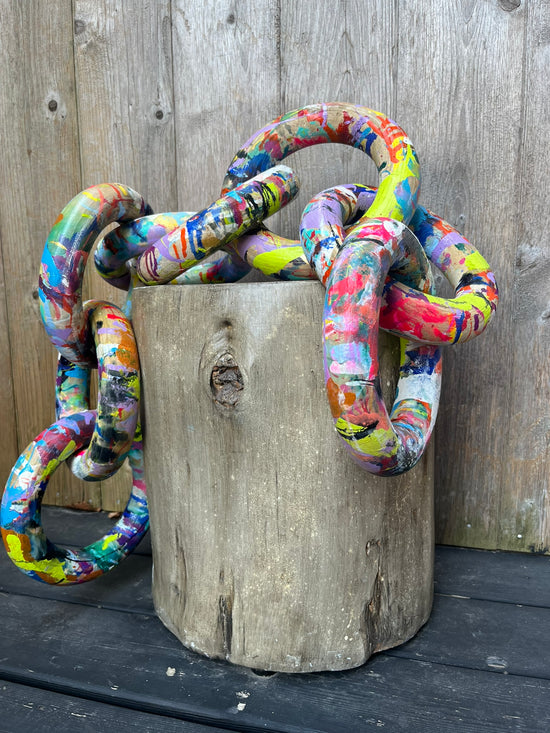 Close-up of interlocked colorful painted wooden rings by Cindy Trestman