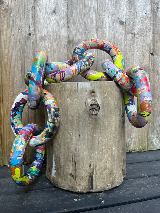 Sculptural wooden rings painted in vibrant abstract colors