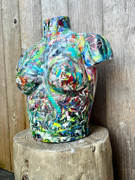 Hand-painted wooden torso sculpture featuring vibrant brushstrokes in green, red, blue, and yellow by artist Cindy Trestman.